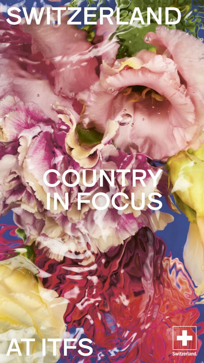 Text: "Switzerland - Country in Focus at ITFS" auf buntem Blumenhintergrund